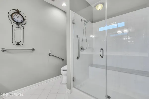 a large kitchen with stainless steel appliances granite countertop a stove a sink and a large refrigerator with wooden floor