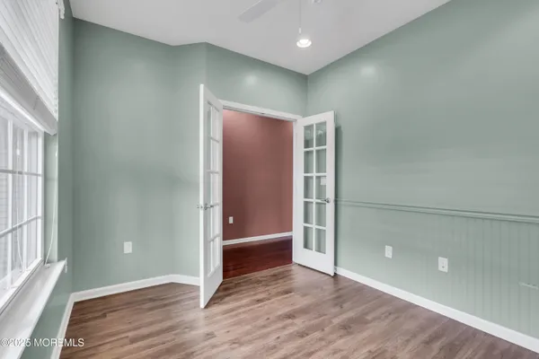 a view of an empty room with wooden floor