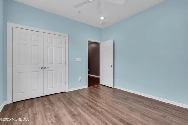 a bedroom with a large bed and a dresser