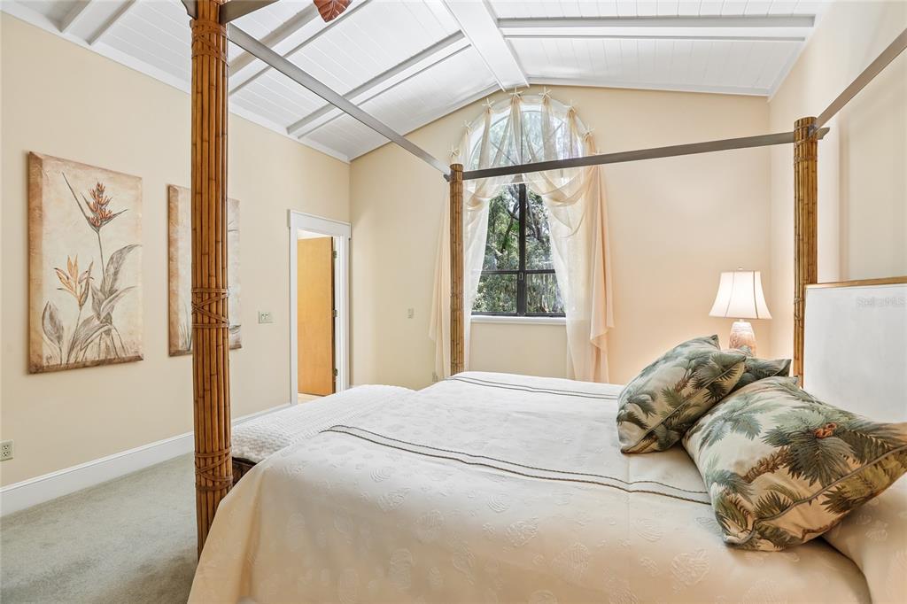 17810 Crawley Road Odessa, FL 33556 - Photo 40 of 76 a bedroom with a large bed and a window with the view of tub