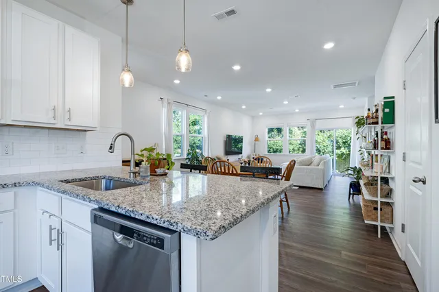 a kitchen with sink stove and cabinets