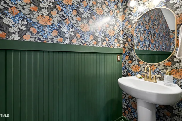 a bathroom with a sink toilet and mirror