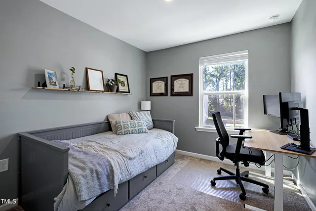 a bedroom with a bed and a desk