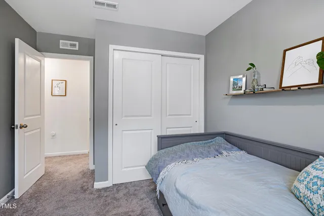a bedroom with a bed and cabinets