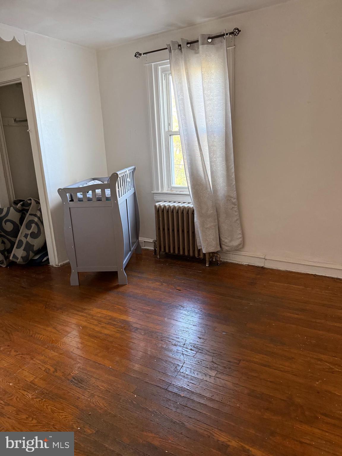 411 Timberlake Road Upper Darby, PA 19082 - Photo 7 of 15 an empty room with wooden floor and windows