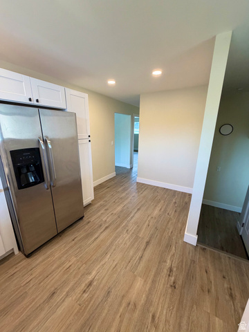 450 13800 South, Unit 2 Draper, UT 84020 - Photo 6 of 21 Open-concept space featuring wood-finish flooring, recessed lighting, and a stainless steel side-by-side refrigerator