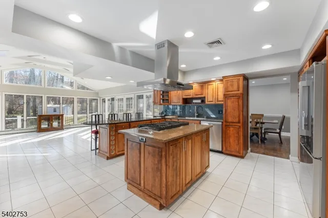 a kitchen with stainless steel appliances granite countertop a stove and a refrigerator