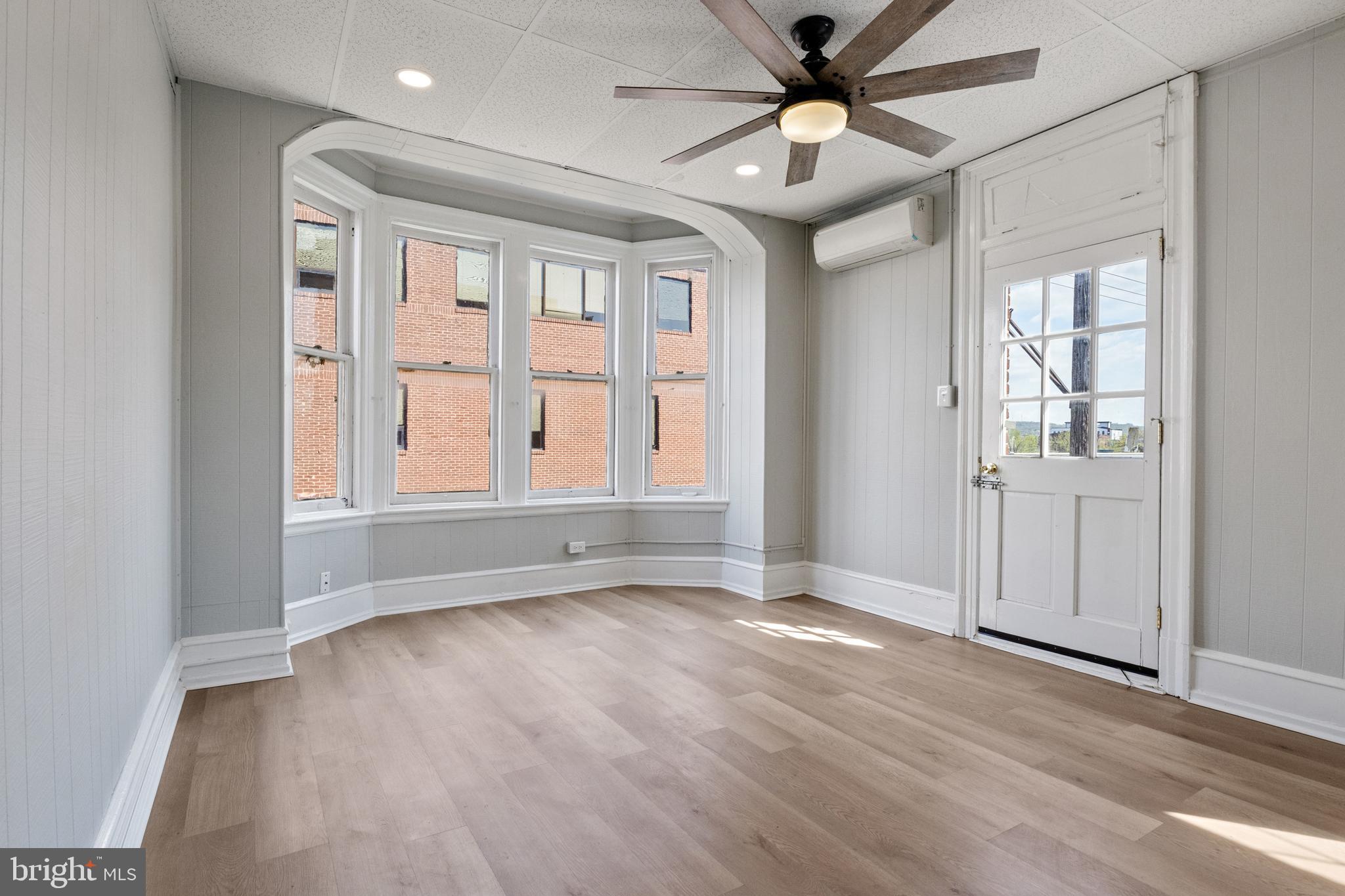 125 North George Street York, PA 17401 - Photo 15 of 56 wooden floor in an empty room with a window