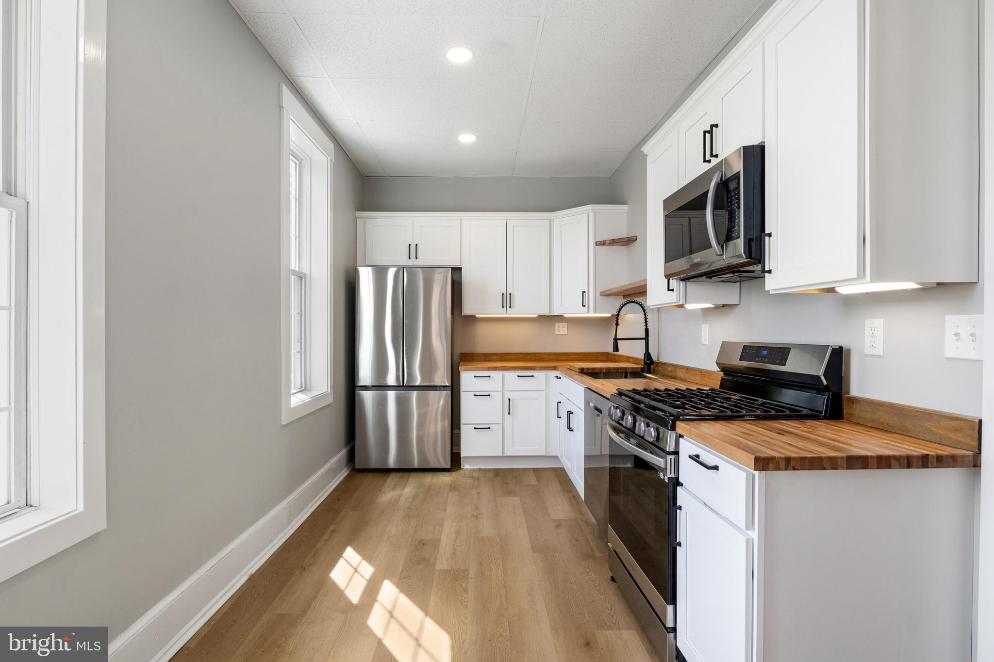 125 North George Street York, PA 17401 - Photo 17 of 56 a kitchen with stainless steel appliances granite countertop a stove a sink and a refrigerator