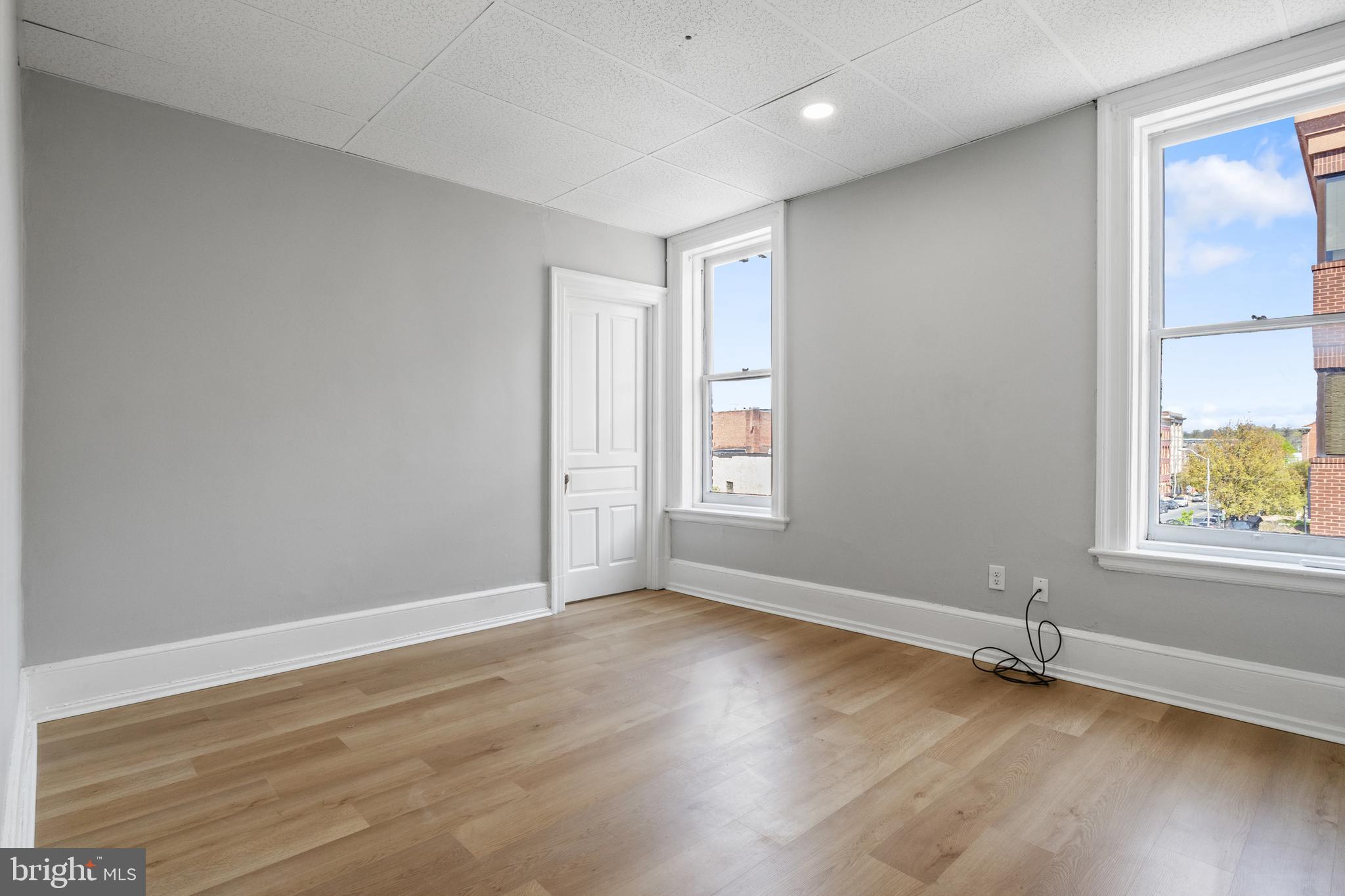 125 North George Street York, PA 17401 - Photo 20 of 56 an empty room with wooden floor and windows