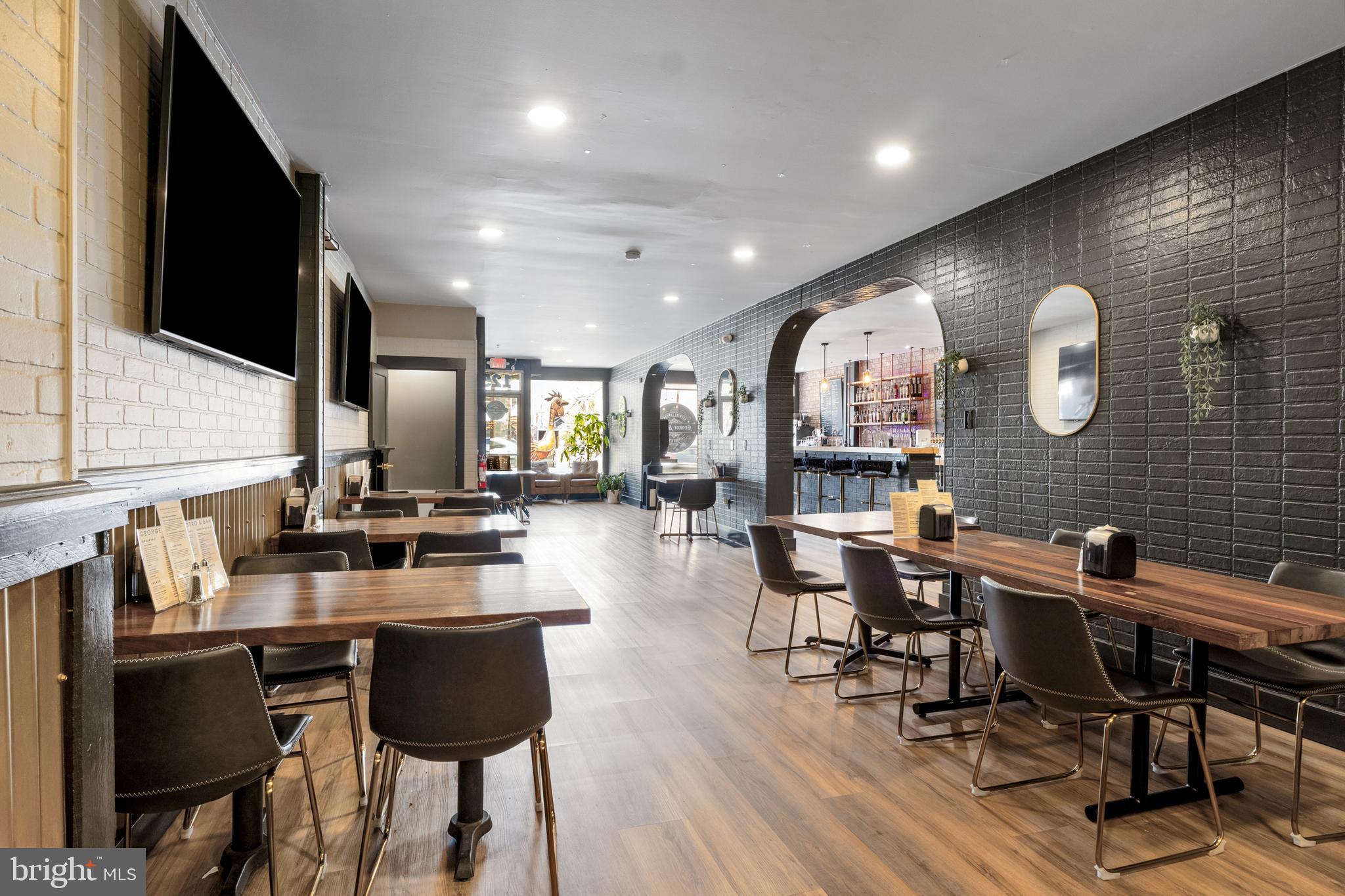 125 North George Street York, PA 17401 - Photo 6 of 56 a kitchen with a table chairs stove and cabinets