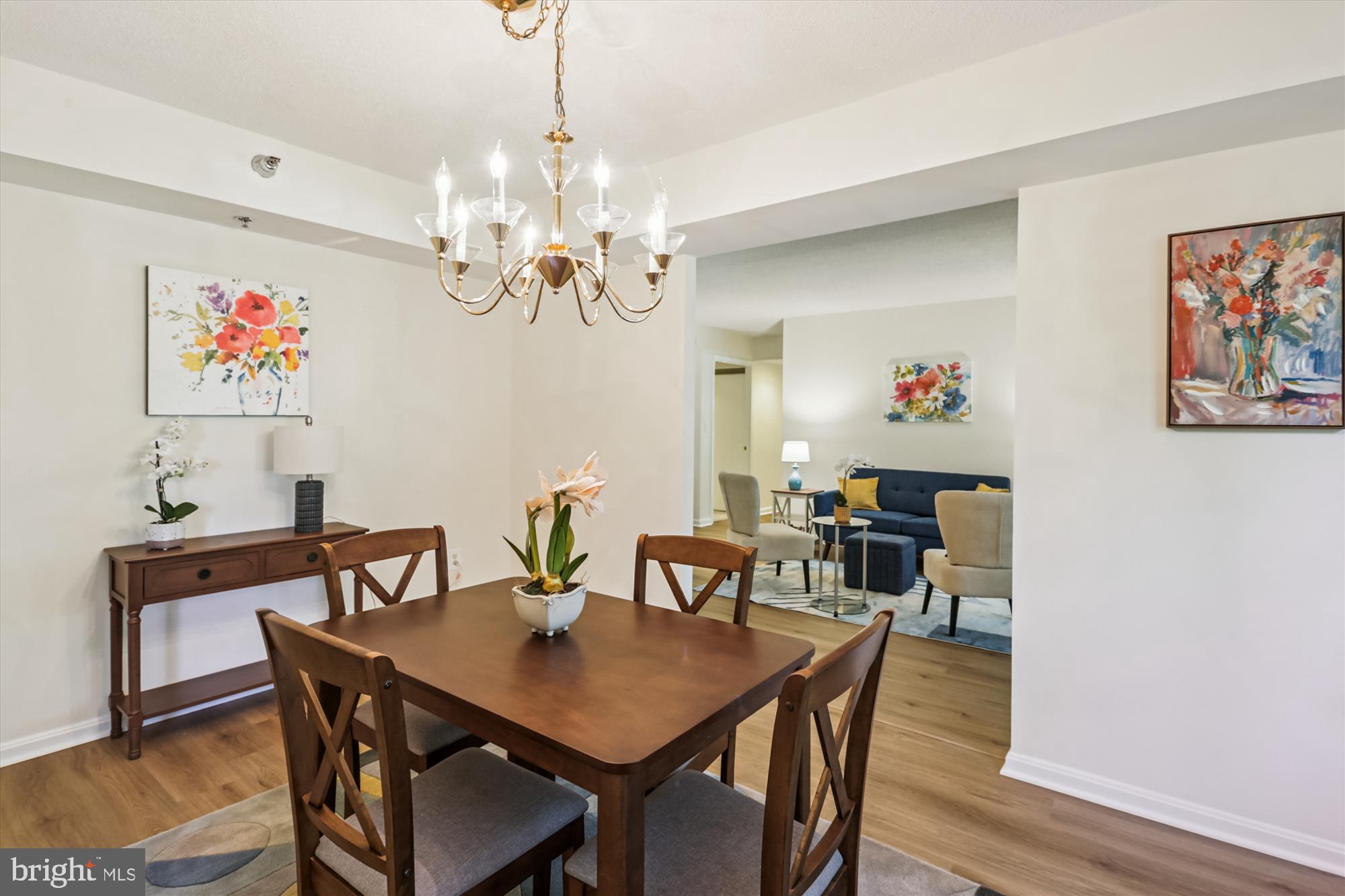 14801 Pennfield Circle, Unit 210 Silver Spring, MD 20906 - Photo 13 of 39 a view of a dining room with furniture a chandelier and wooden floor