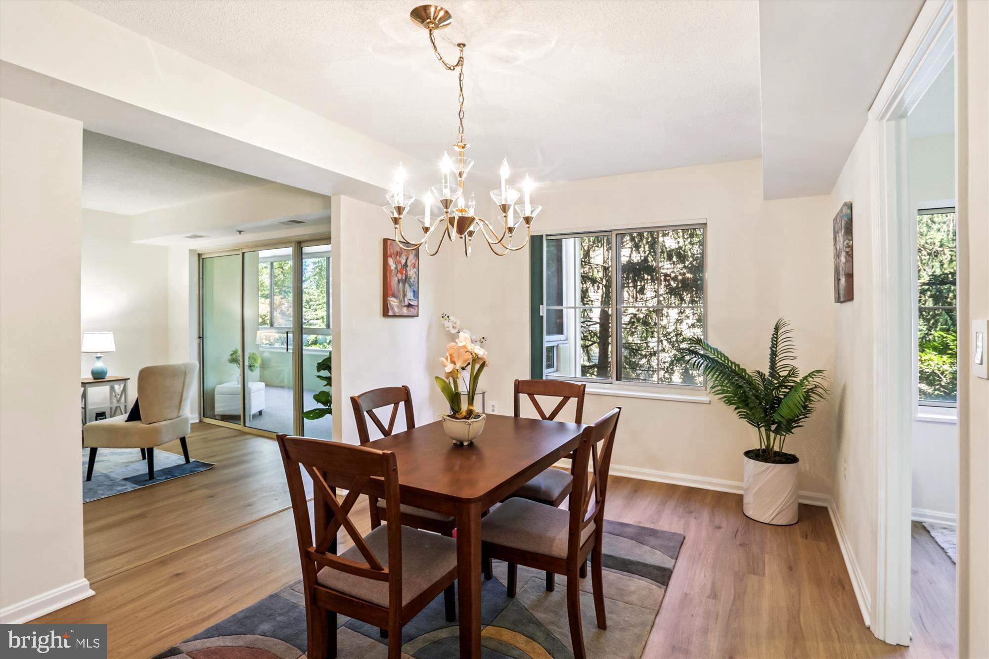 14801 Pennfield Circle, Unit 210 Silver Spring, MD 20906 - Photo 2 of 39 a view of a dining room with furniture window and wooden floor
