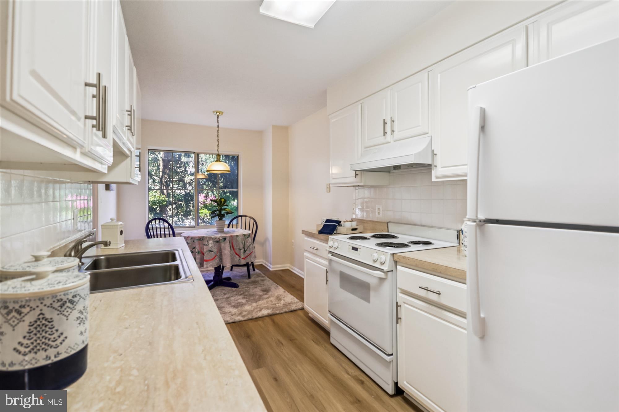 14801 Pennfield Circle, Unit 210 Silver Spring, MD 20906 - Photo 3 of 39 a kitchen with granite countertop a stove a sink and a refrigerator