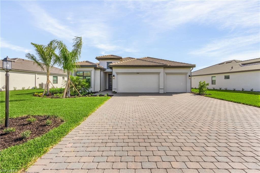 20662 Greenwich Place Estero, FL 33928 - Photo 1 of 26 a front view of a house with a yard and garage