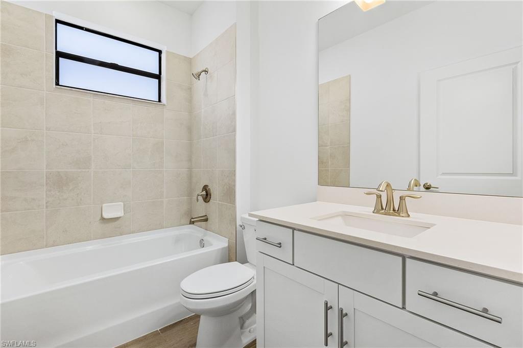 20662 Greenwich Place Estero, FL 33928 - Photo 14 of 26 a bathroom with a sink a toilet and a bathtub
