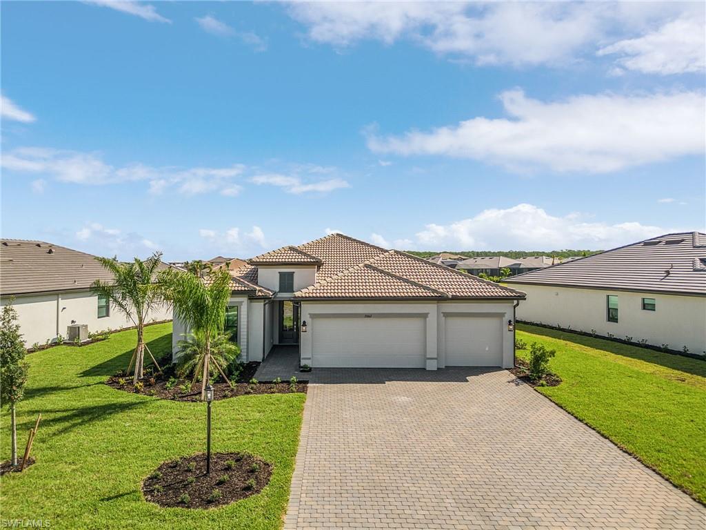 20662 Greenwich Place Estero, FL 33928 - Photo 23 of 26 a front view of a house with a yard and garage