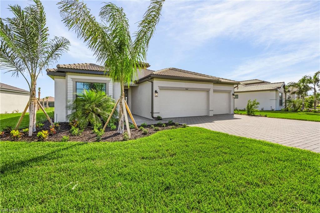 20662 Greenwich Place Estero, FL 33928 - Photo 3 of 26 a front view of house with yard and green space