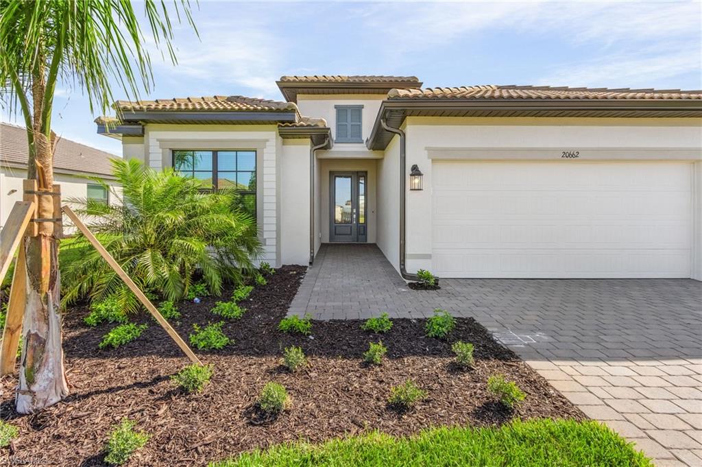 20662 Greenwich Place Estero, FL 33928 - Photo 4 of 26 a front view of a house with garden