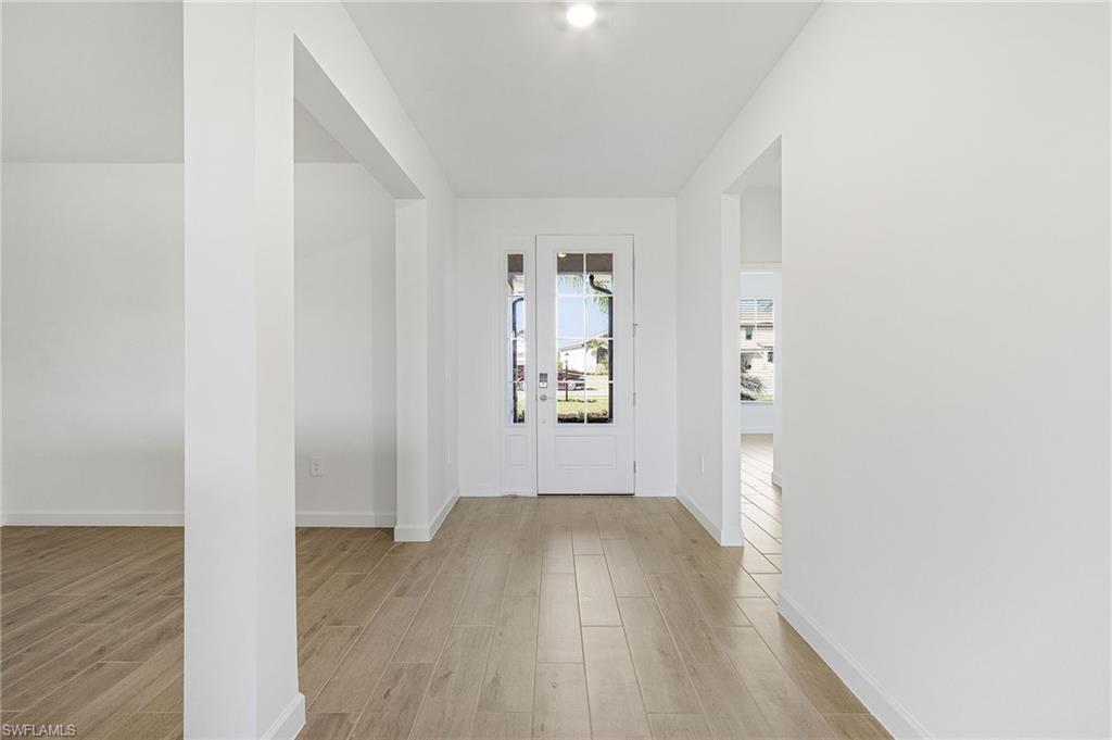 20662 Greenwich Place Estero, FL 33928 - Photo 5 of 26 an empty room with wooden floor and windows