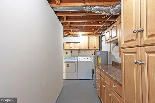 a view of storage and utility room with washer and dryer