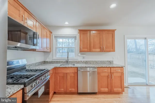 a kitchen with granite countertop a stove and a sink