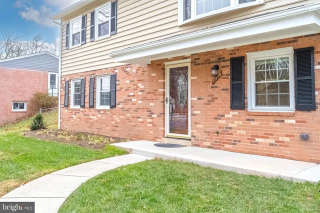 front view of a brick house with a yard