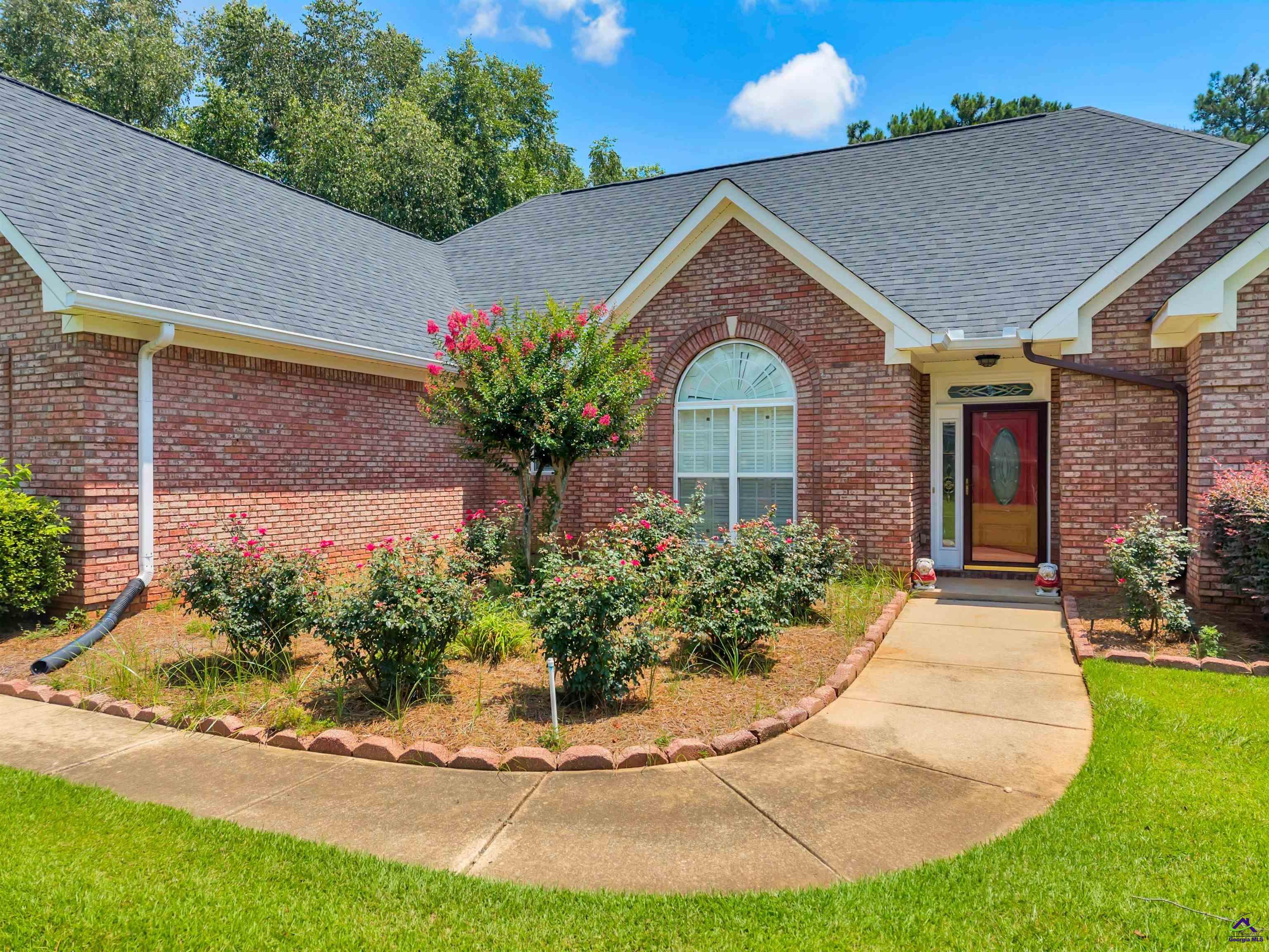 206 North Hampton Place Perry, GA 31069 - Photo 8 of 20 a front view of a house with a yard
