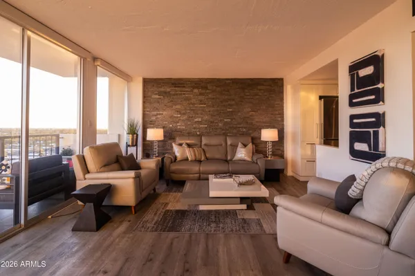 a living room with furniture and a floor to ceiling window