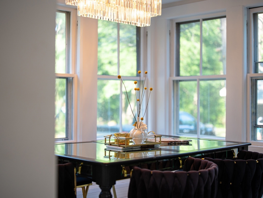 24 Miller Road Wilmington, MA 01887 - Photo 15 of 40 a table and chairs in a room next to a window