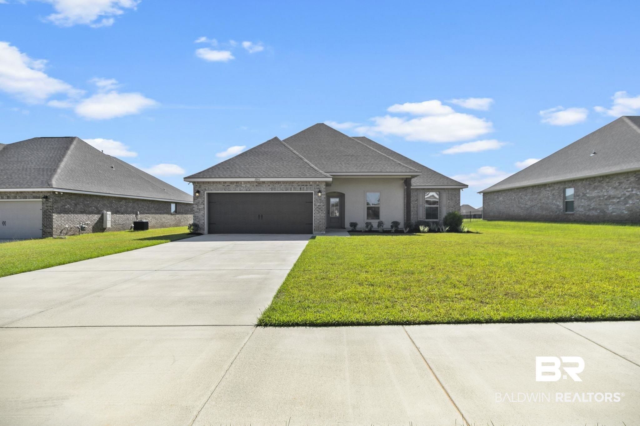 10140 Chipper Lane Foley, AL 36535 - Photo 2 of 72 View of front of home with a front lawn and a garage