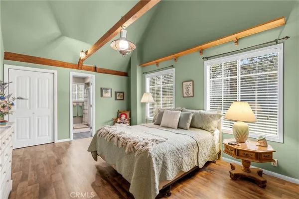 a bedroom with a bed and a large window