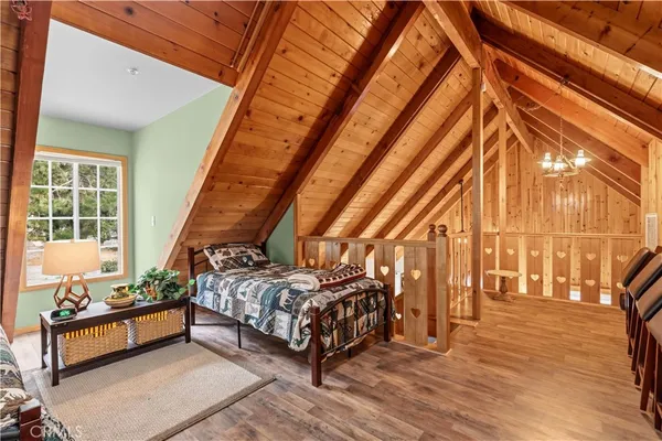 a bed sitting in a bedroom next to a window