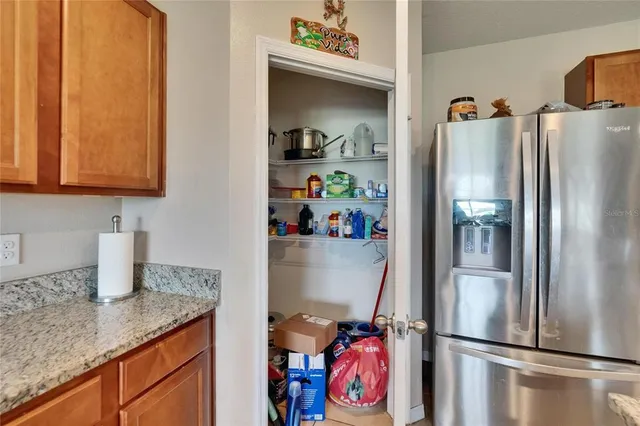 a living room with furniture and a view of kitchen