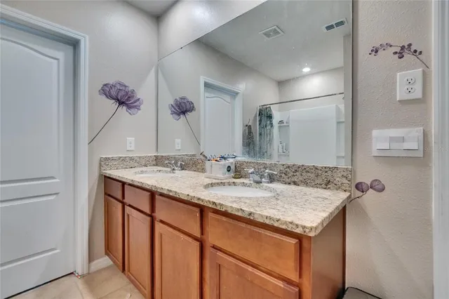 a bedroom with a bed and a night stand