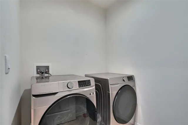 a view of a backyard with table and chairs and potted plants