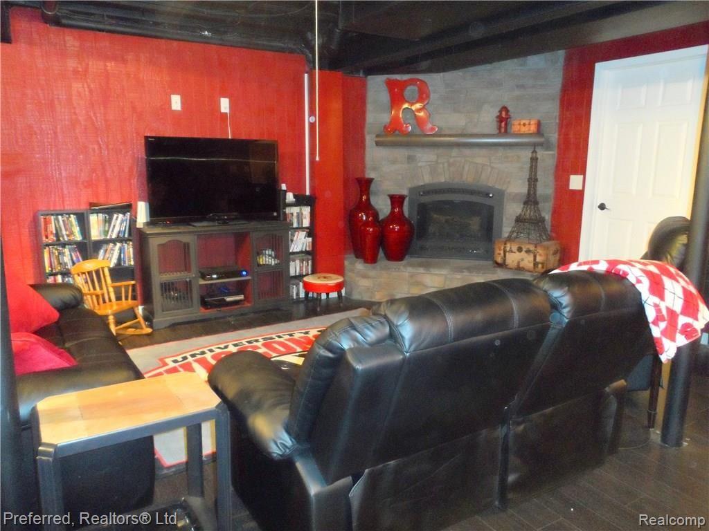 1289 Woodland Springs Drive Howell, MI 48843 - Photo 25 of 39 FINISHED BASEMENT WITH NEWER GAS FIREPLACE.