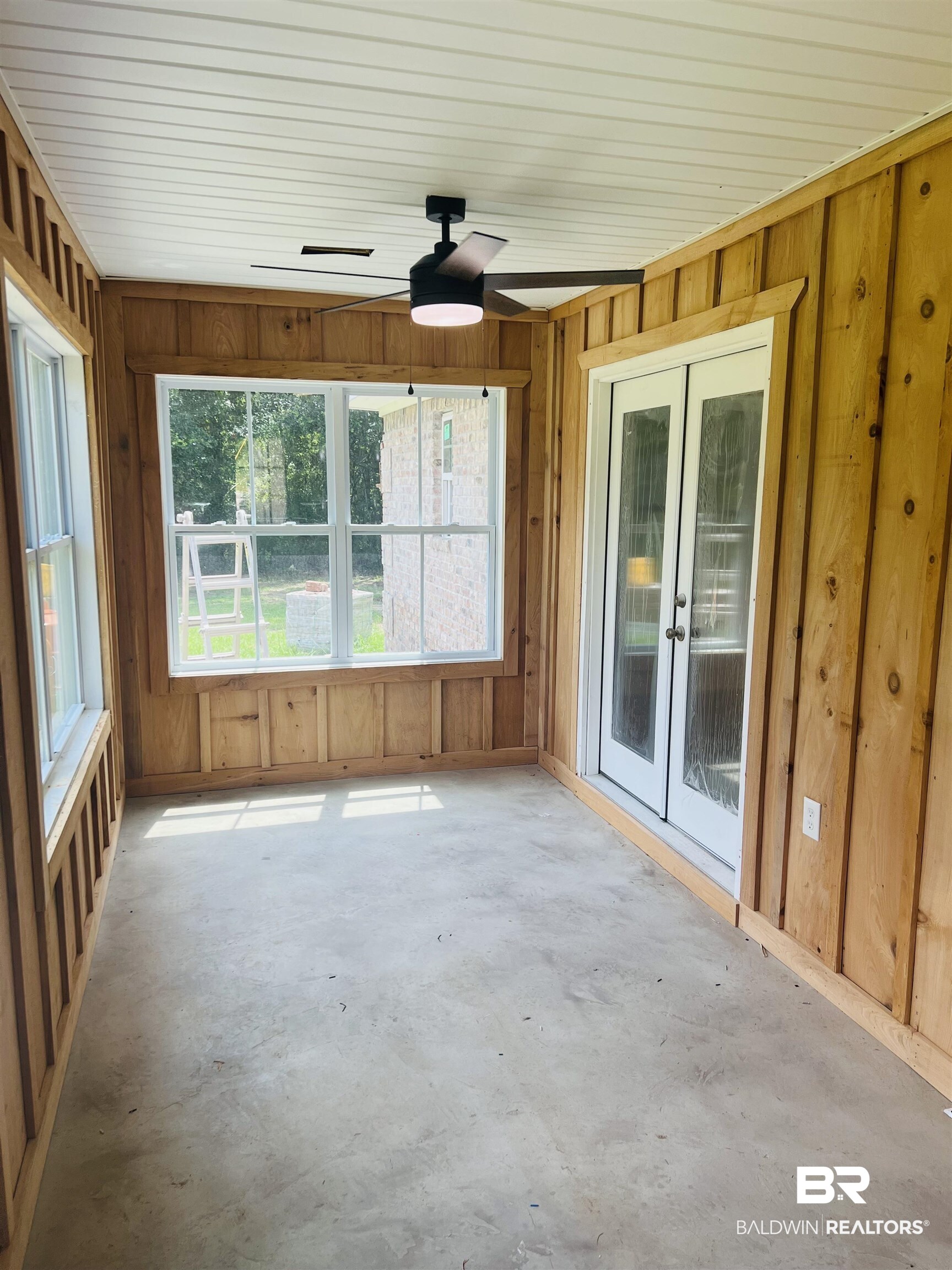 29685 Gardner Road Elberta, AL 36530 - Photo 14 of 16 Enclosed porch featuring natural wood-paneled walls, a white paneled ceiling, and concrete flooring