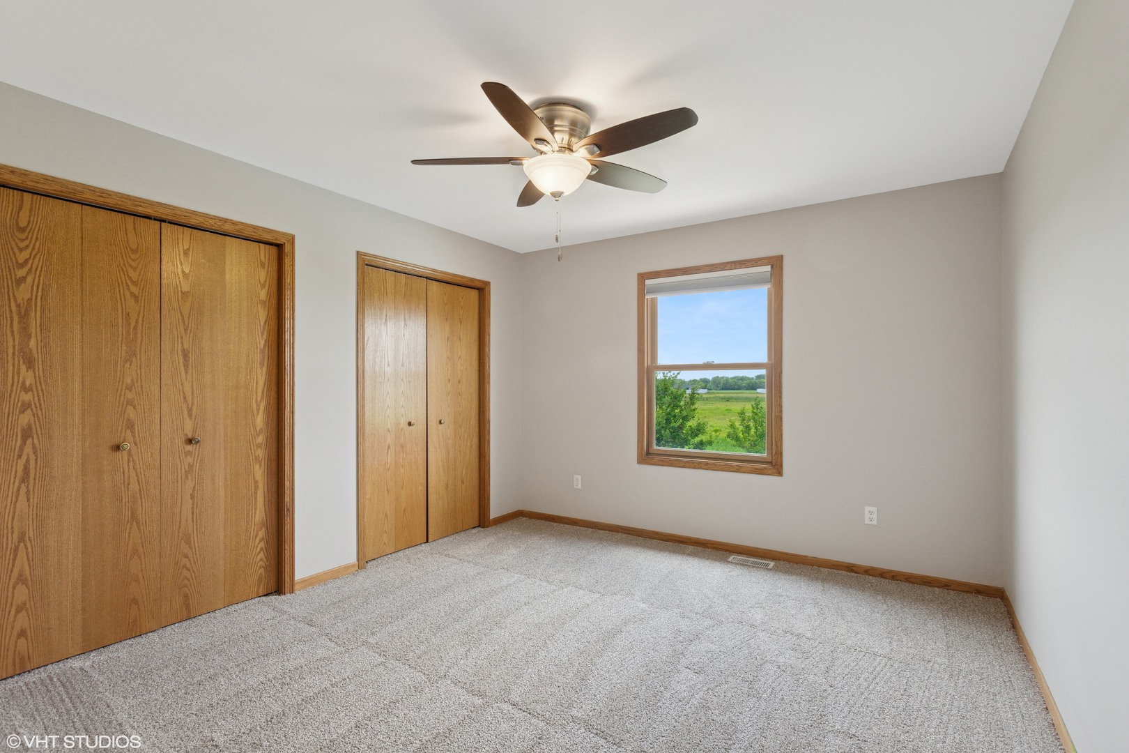 2033 Willow Brook Drive Bourbonnais, IL 60914 - Photo 12 of 24 a view of a livingroom with a ceiling fan and window