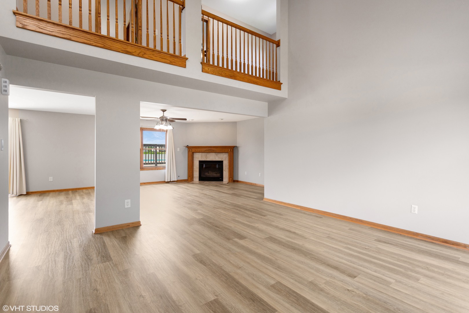2033 Willow Brook Drive Bourbonnais, IL 60914 - Photo 2 of 24 a view of an empty room with wooden floor fireplace and a window