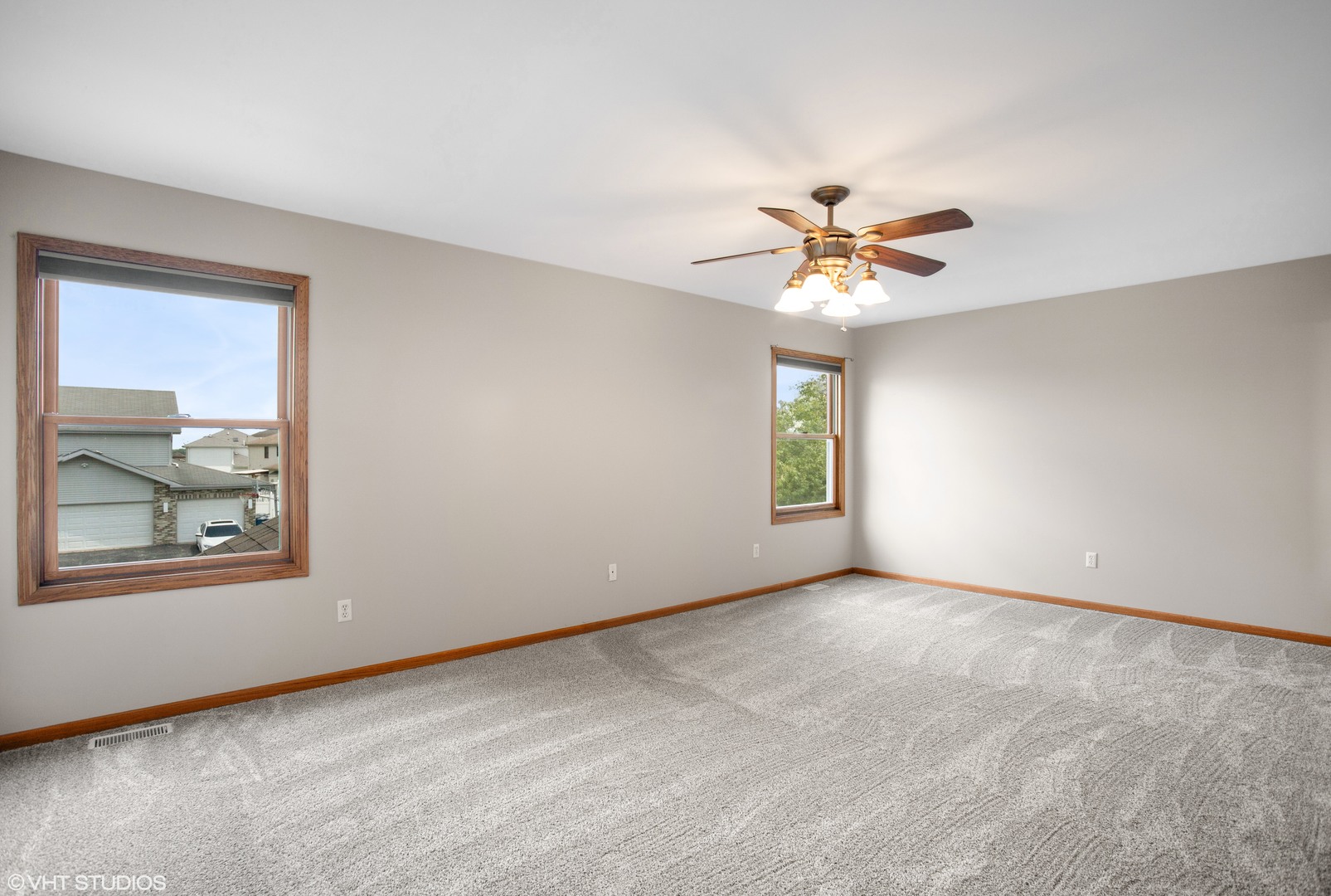 2033 Willow Brook Drive Bourbonnais, IL 60914 - Photo 9 of 24 an empty room with windows and chandelier fan