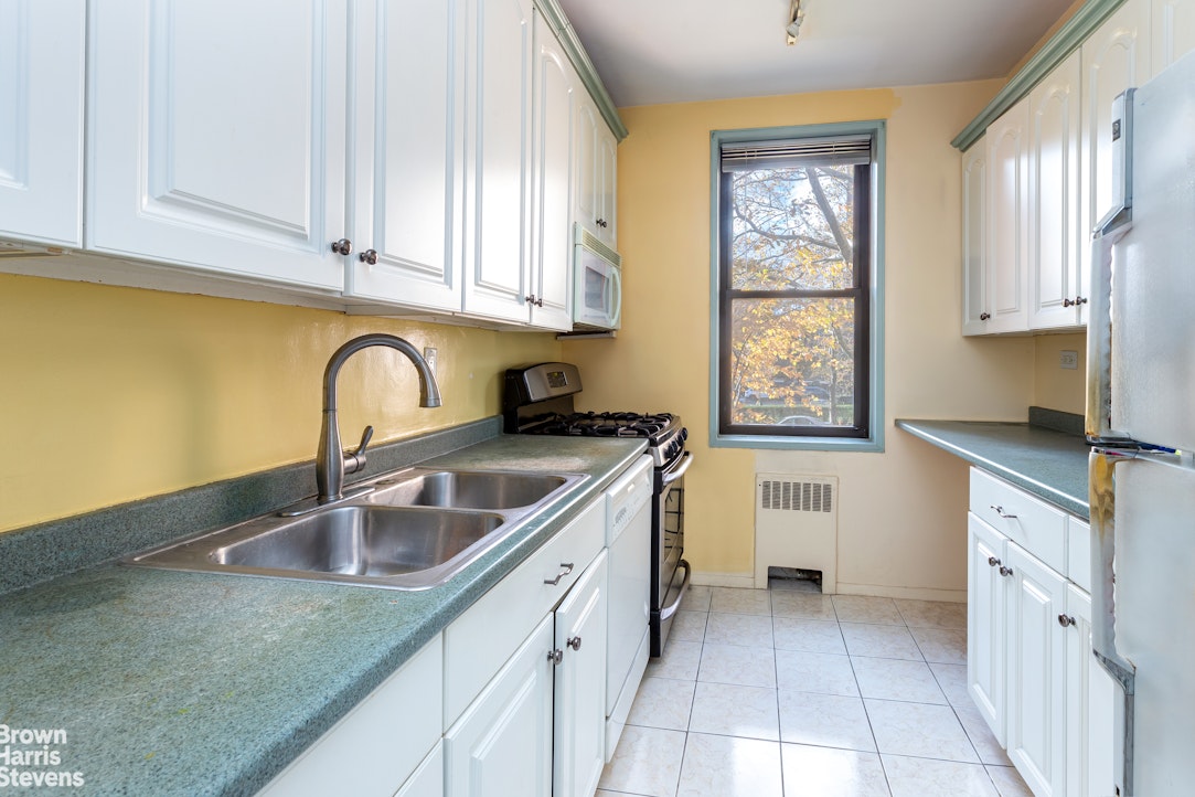 611 West 239th Street, Unit 3F Bronx, NY 10471 - Photo 3 of 12 a kitchen with stainless steel appliances granite countertop a sink dishwasher a stove and a microwave oven with cabinets