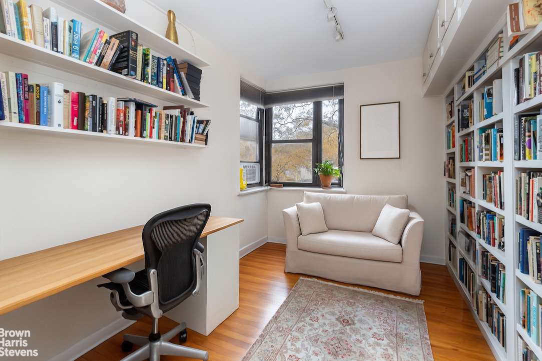 611 West 239th Street, Unit 3F Bronx, NY 10471 - Photo 7 of 12 a living room with furniture a book shelf and a book shelf