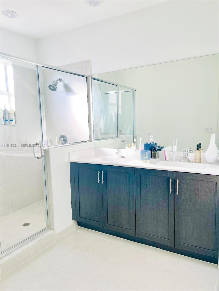 2624 Southeast 11th Court, Unit 2624 Homestead, FL 33035 - Photo 12 of 19 a bathroom with a shower sink and mirror