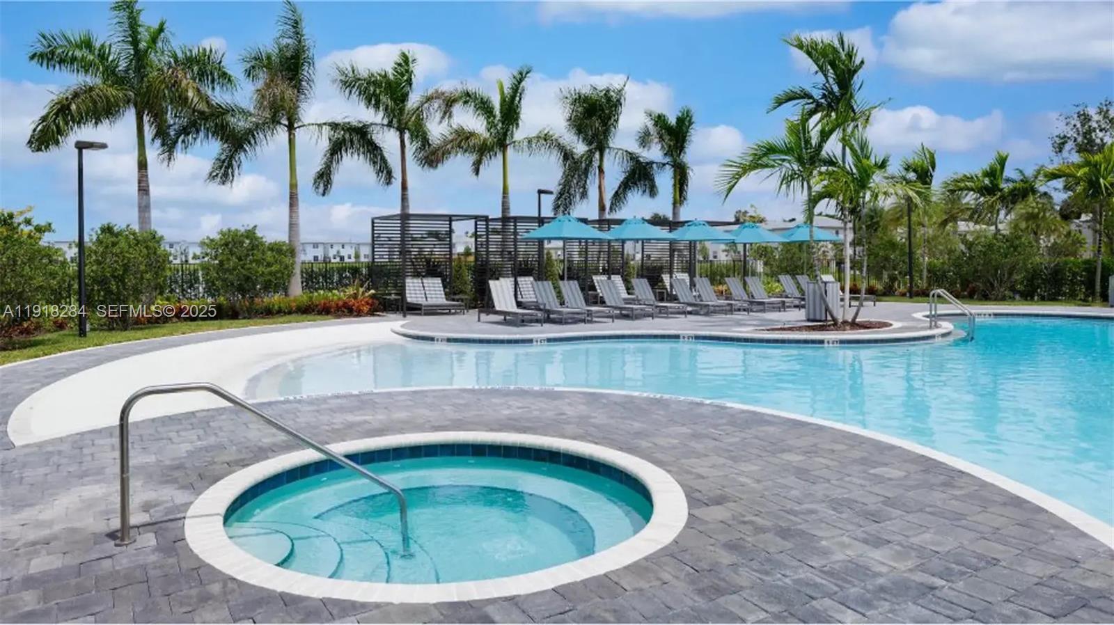 2624 Southeast 11th Court, Unit 2624 Homestead, FL 33035 - Photo 4 of 19 a view of a swimming pool with a yard