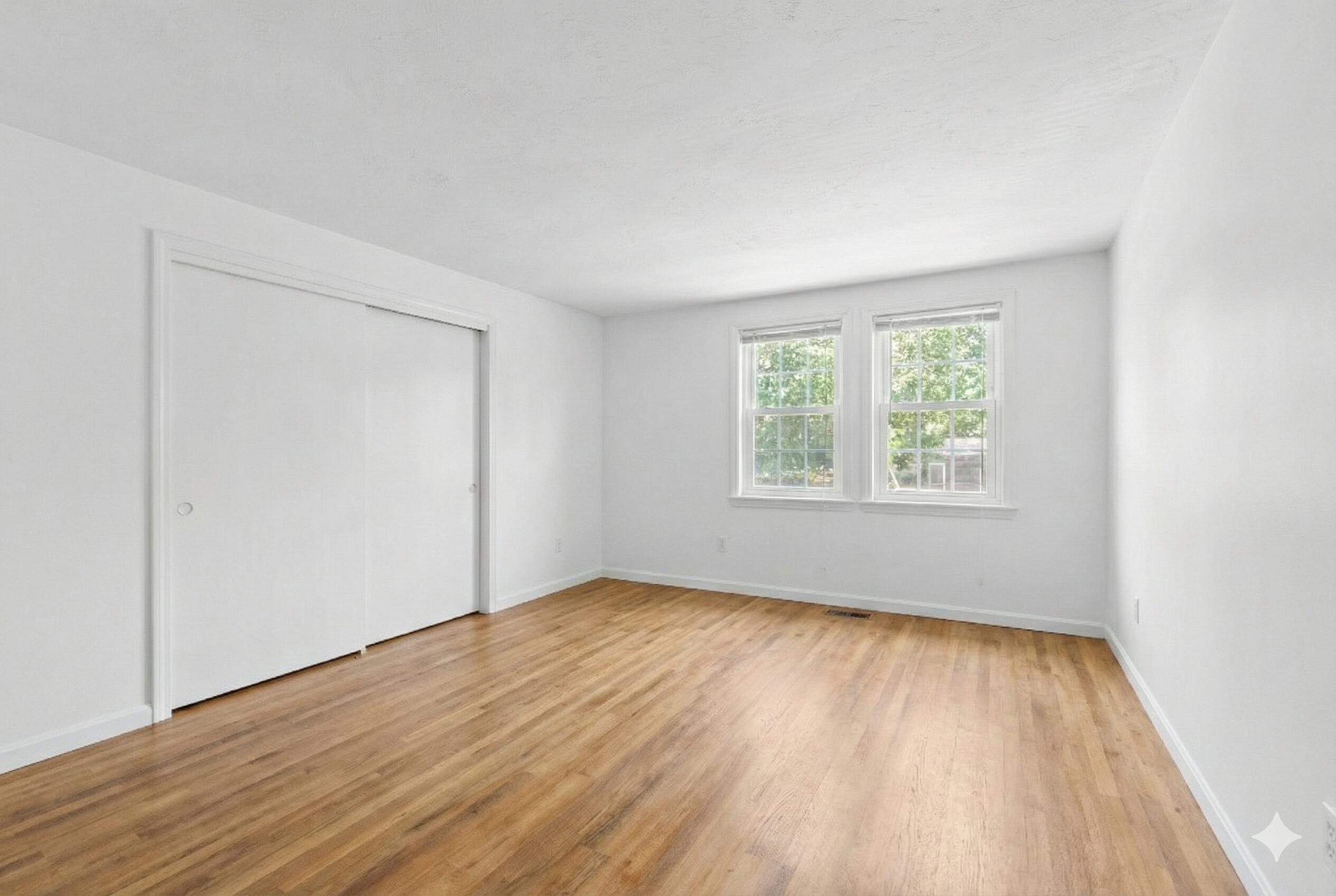 300 Falmouth Road, Unit 20C Mashpee, MA 02649 - Photo 15 of 38 an empty room with wooden floor and windows