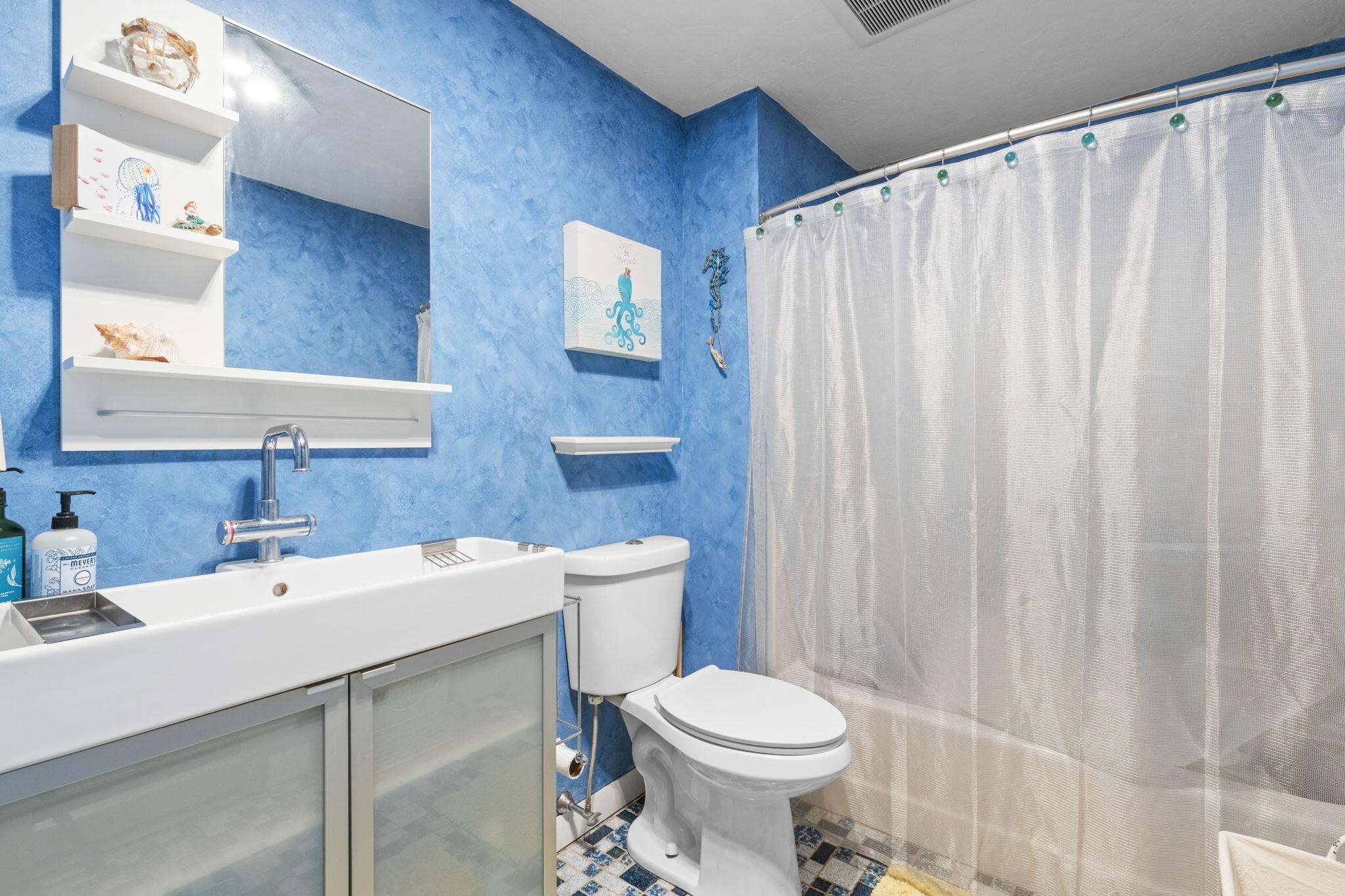 300 Falmouth Road, Unit 20C Mashpee, MA 02649 - Photo 31 of 38 a bathroom with a sink a toilet and shower curtain