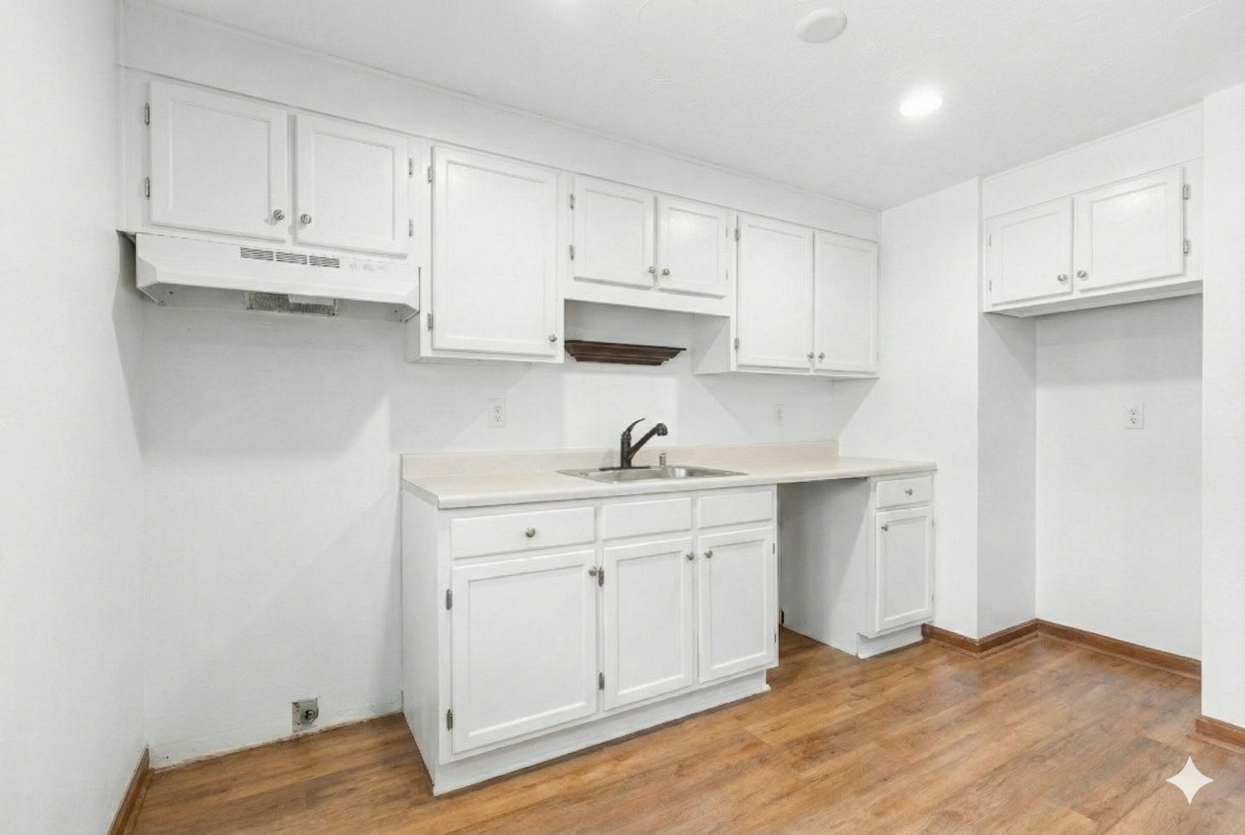 300 Falmouth Road, Unit 20C Mashpee, MA 02649 - Photo 9 of 38 a kitchen with white cabinets and sink