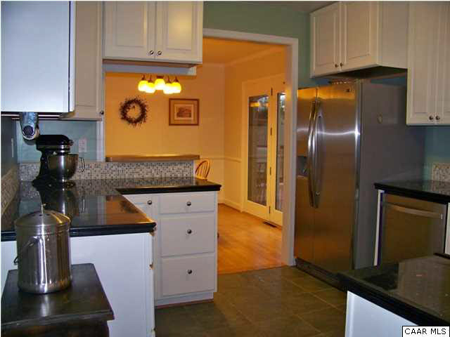 1312 Grove Road Charlottesville, VA 22901 - Photo 4 of 19 Remodeled Kitchen has new cabinets, granite counters, tile backsplash, stainless appliances, & ceramic tile floor.