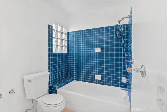 a bathroom with a bathtub and toilet
